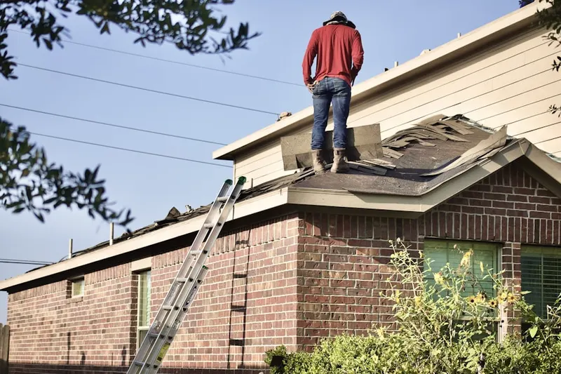 Professional roofer working on a residential roof in Colora